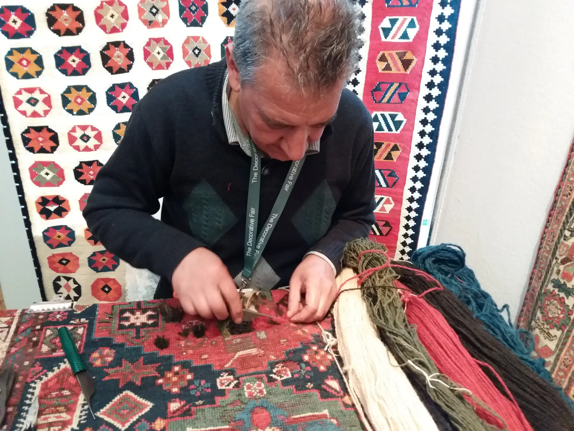 Rugs hanging on a dealer's stand at LARTA